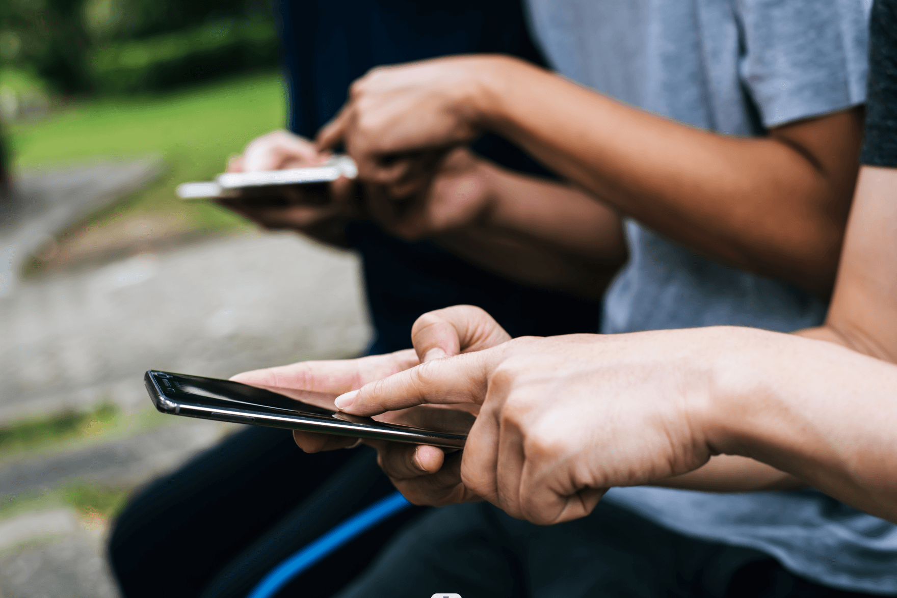 close-up-friends-hands-play-with-smartphone-together